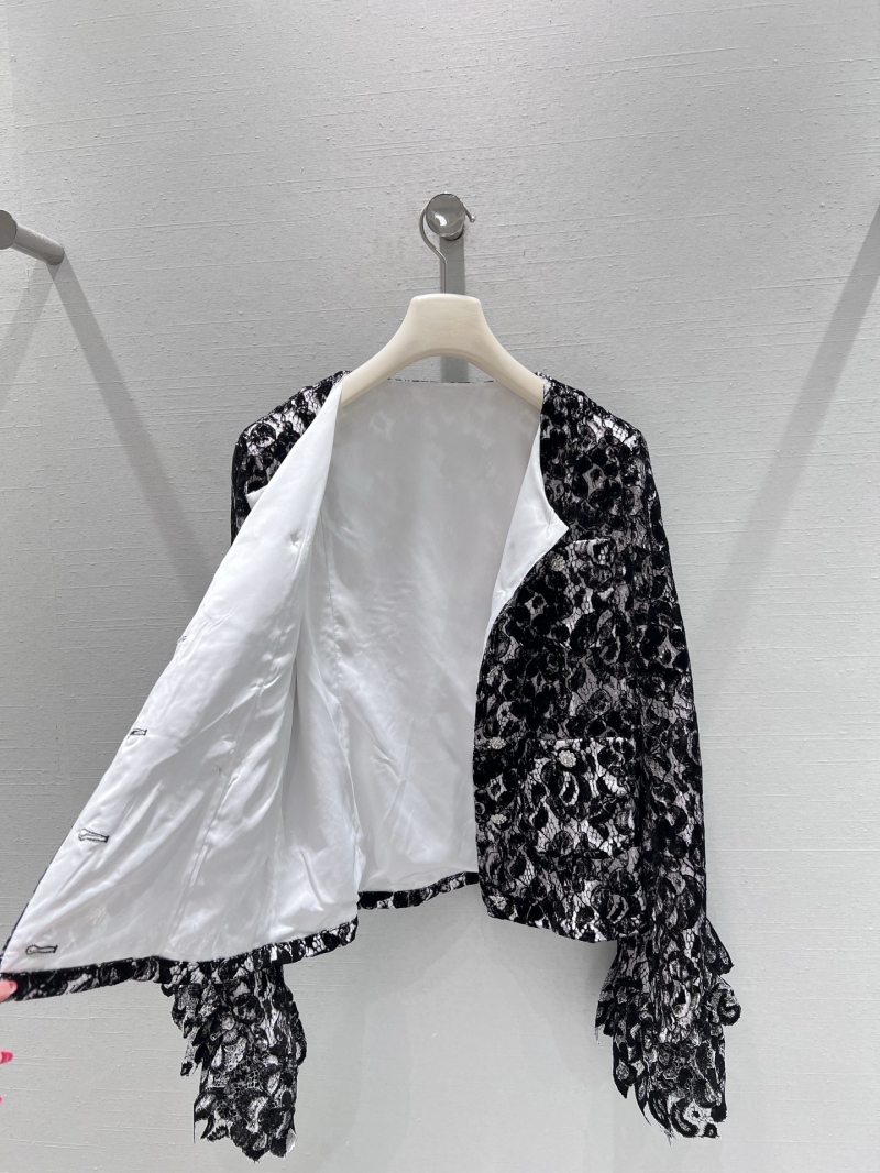 Chanel Elegant Long-Sleeved Lace Blouse in Black & White Floral Pattern with Pearl Buttons and Ruffled Cuffs