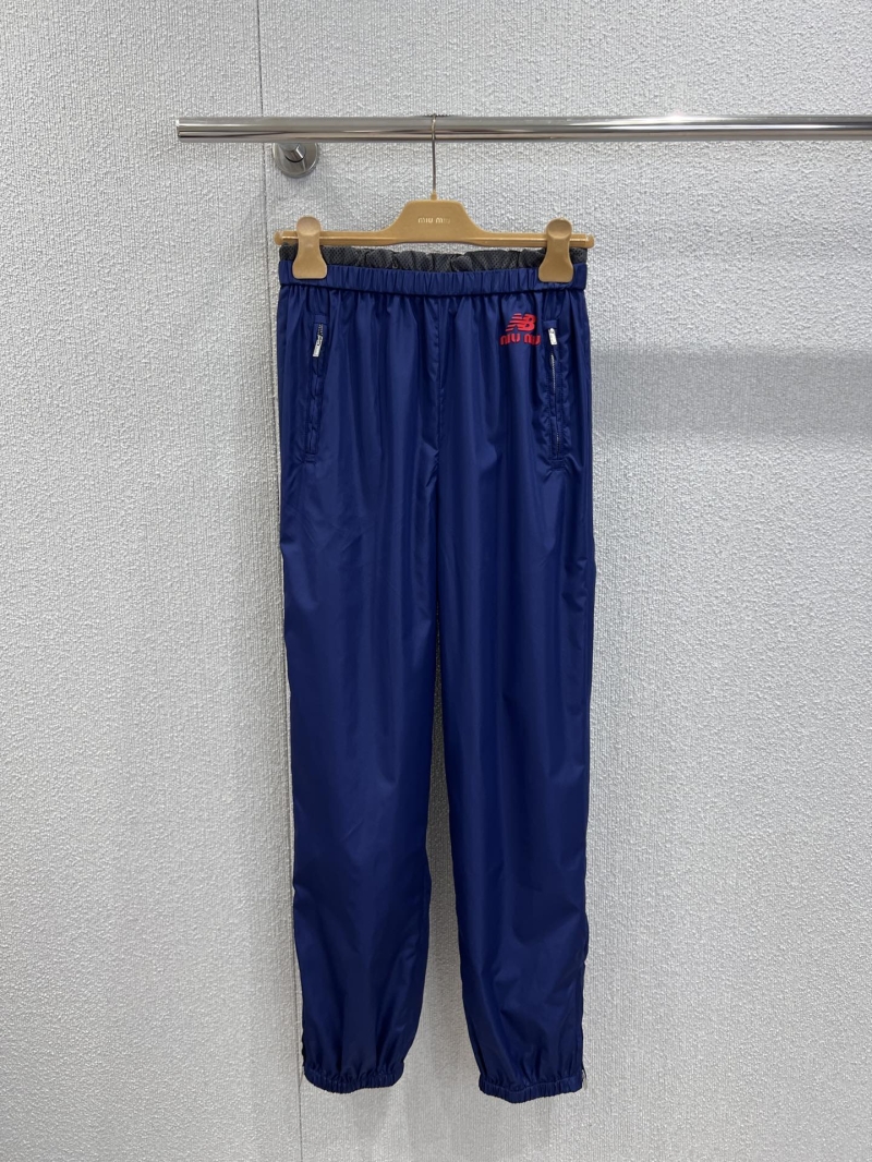 Miu Miu x New Balance Navy Blue Track Pants - Luxury Streetwear Joggers with Red Embroidered Logo, Zippered Pockets, and Elasticated Cuffs